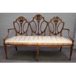 A 19th century floral polychrome painted satinwood triple back sofa, on tapering square supports,