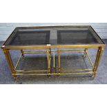 A nest of three 20th century smoked glass and lacquered brass occasional tables,