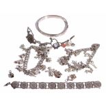 A silver curb link charm bracelet, fitted with eleven charms, including a crocodile,