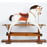 A wooden grey painted rocking horse, early 20th century, on a stained pine base,