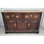 An oak low dresser, 18th century, of panelled construction, with two drawers and cupboard below,