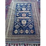 A Yagabedir prayer style Turkish rug, the dark indigo mehrab with stylised madder flowerheads,