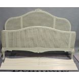 A modern white painted and canework kingsize bed, 185cm wide x 180cm high.