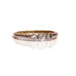 A gold and platinum, diamond set three stone ring,