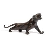 A Japanese bronze figure of a prowling tiger, 20th century, signed, 29cm. length.