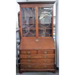 A George III mahogany bureau bookcase, the pair of glazed doors over fitted interior,