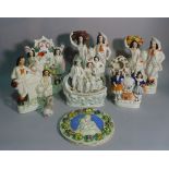 A group of eight 19th century and later Staffordshire flatback figures, the tallest 35cm high,