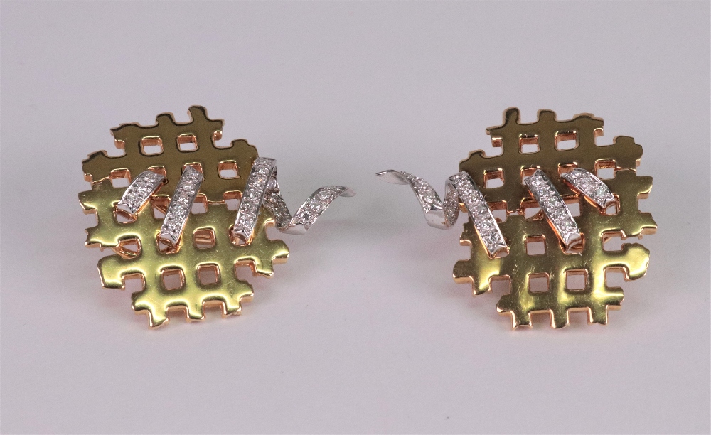 A pair of 18ct white and yellow gold and diamond set earclips of abstract lattice design,