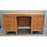 Robert Mouseman Thompson; A 20th century blonde oak dressing table with six drawers about the knee,