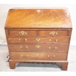 A George III mahogany bureau with two short over three long graduated drawers on bracket feet,