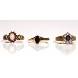A 9ct gold, opal and garnet set oval cluster ring, decorated with pierced shoulders,
