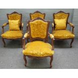 A set of four Louis XV style walnut framed open armchairs with 'C' scroll crest and serpentine seat