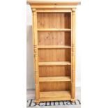 A modern pine floorstanding five tier, open bookcase on bun feet, 92cm wide x 202cm high.