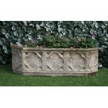 A reconstituted stone Gothic Revival garden planter, of pointed rectangular form,