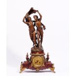 After Bruchon, a French figural spelter and rouge marble mantel clock, circa 1900,