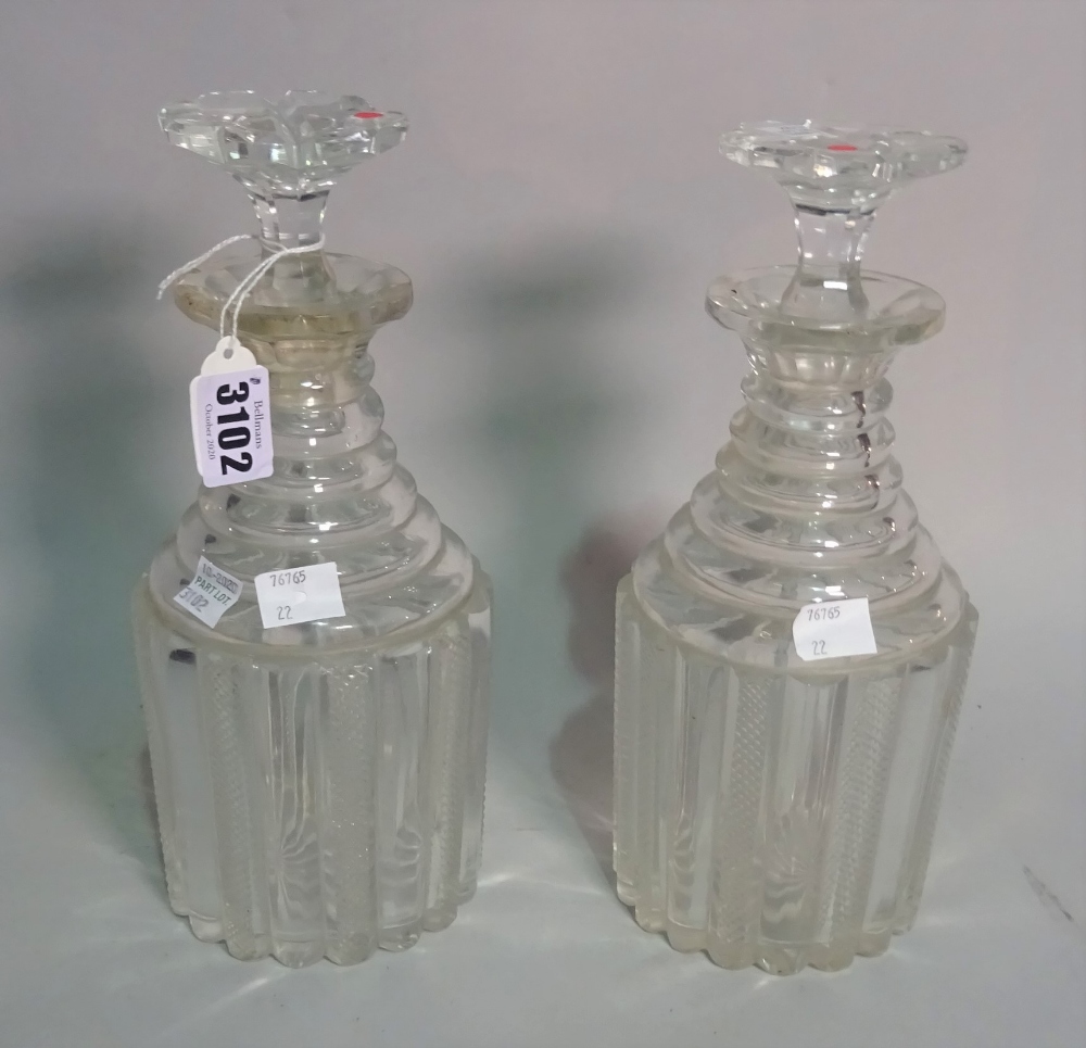 A pair of late Regency cut glass decanters, with stepped necks, 28cm tall.