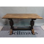 An 18th century style oak refectory dining table on bulbous turned supports, 153cm wide x 75cm high.