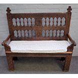 A 19th century French Gothic Revival oak settle with carved and turned back,