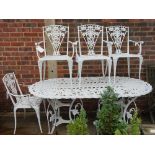 A modern white painted metal oval garden table,