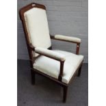 A Victorian Gothic Revival oak open armchair, with pointed back and octagonal arm supports,