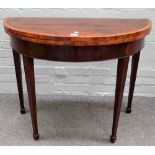 A near pair of George III Kingwood banded mahogany D-shaped card tables on tapering square supports,