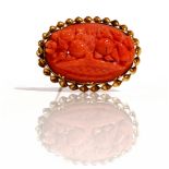 An oval coral brooch, carved as a basket of flowers,