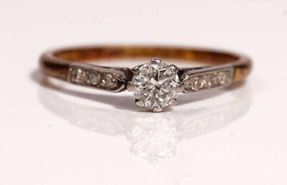 A gold and platinum ring, claw set with the principal circular cut diamond at the centre, - Image 2 of 2