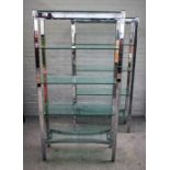 Probably Merrow Associates, a pair of 20th century chrome and glass five tier free standing shelves,