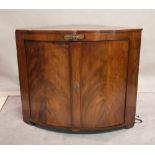 A large 19th century mahogany bowfront corner cabinet with gilt metal mounts,