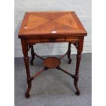 An Edwardian mahogany envelope card table, on four splayed and turned supports,