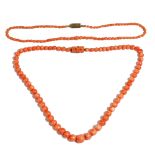 A single row necklace of graduated coral beads, on a silver and carved coral rectangular clasp,