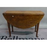An 18th century oak drop flap dining table on tapering supports and pad feet,