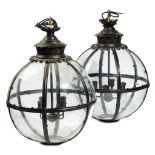 A pair of modern black painted brass globe lanterns, with an internal four light pendant fitment,