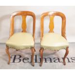 A pair of 19th century continental mahogany side chairs on carisole supports,