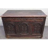 A 17th century oak coffer, the plank top over triple panel front, 120cm wide x 75cm high.