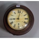 An early 20th century German circular wall clock, one key and one pendulum, 27cm diameter.
