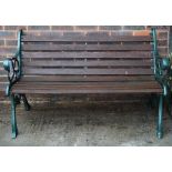 A modern cast aluminium and slatted hardwood garden bench, 128cm wide x 79cm high.