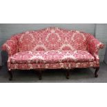 Baker Furniture; a George I style humpback sofa on eight mahogany scroll supports,