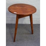 A George III fruitwood cricket table, the circular top on three canted square supports,