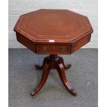 A George III style inlaid mahogany octagonal centre table with a pair of frieze drawers on four