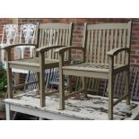 A pair of grey painted hardwood garden open armchairs, 61cm wide x 89cm high.