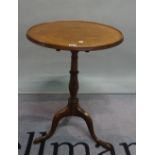 A 19th century mahogany tripod table, the circular dished top on downswept supports,