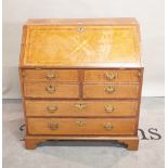 A late 19th century oak bureau with two short and two long drawers on bracket feet,