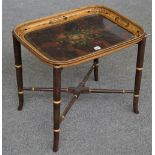 A Victorian papier-mâché tray, decorated with a floral reserve against a faux burr wood ground,