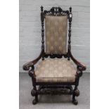 A William and Mary and later, walnut open armchair with outswept arms and carved stretcher,