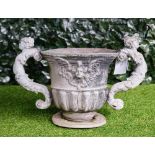A 19th century lead twin handle urn, with semi fluted body, and turned base,