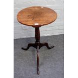 A George III oak pedestal table, the circular top on a vase and ring turned pillar and tripod base,