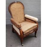 A 19th century oak framed easy armchair with angle adjustable back