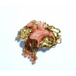 A Victorian gold and coral broach designed as a floral and foliate spray with pendant tassels