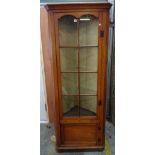 An early 20th century oak glazed floor standing corner cabinet, 78cm wide x 198cm tall.